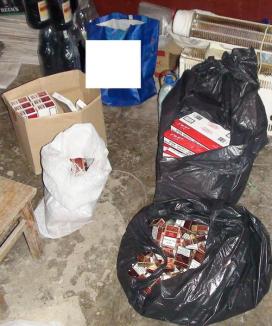 Mii de pachete cu ţigări de contrabandă şi o puşcă cu aer comprimat deţinută ilegal, confiscate de poliţişti